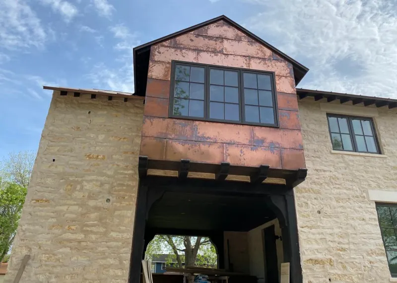 Copper metal panel facade on a stone building for Roof Repair in McAlester